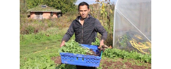 A person holding freshly-harvested produce